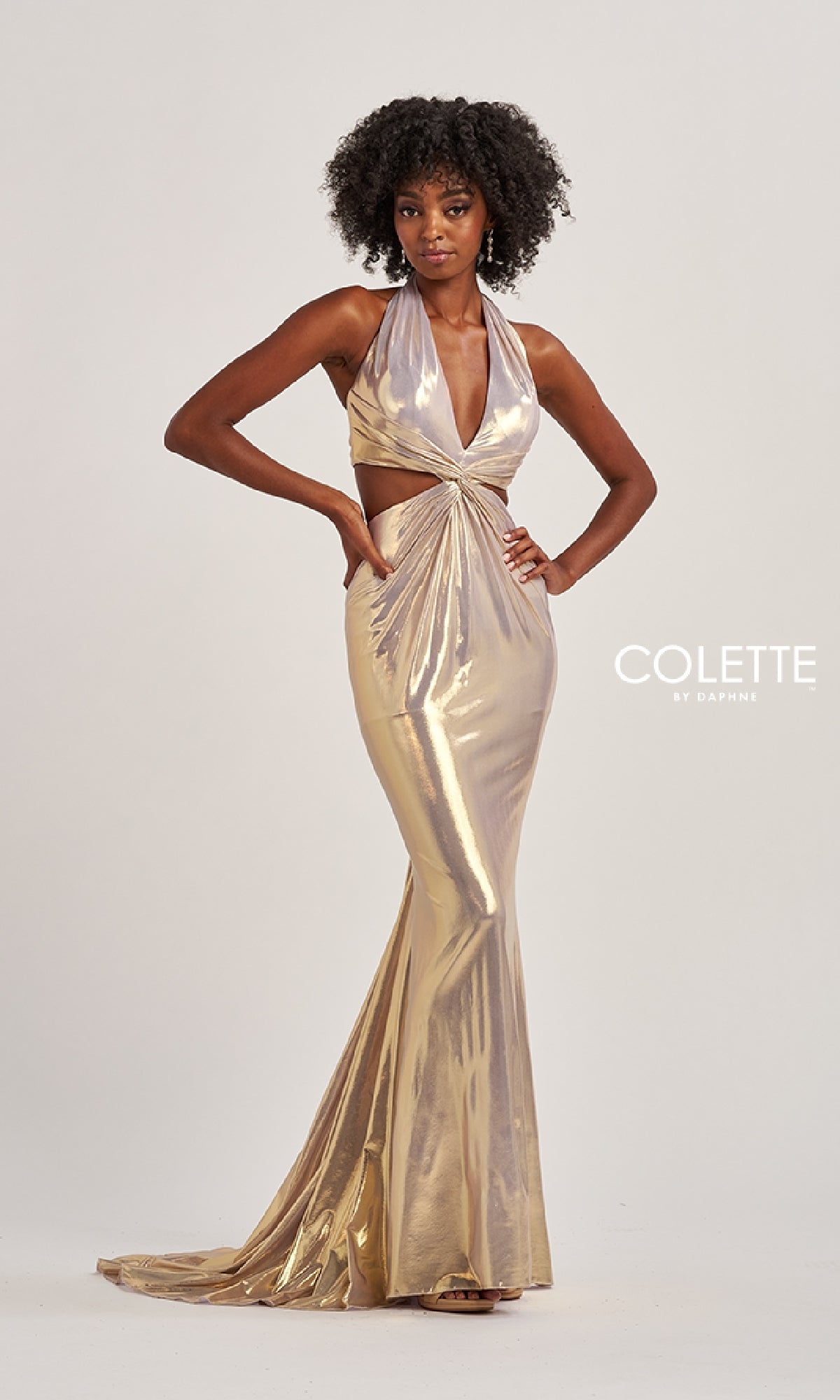 A woman poses in the Colette CL8505 long prom dress—a sleeveless, metallic gold halter gown featuring side cutouts, an open back, and a floor-length skirt. The Colette by Daphne logo is displayed on the right.